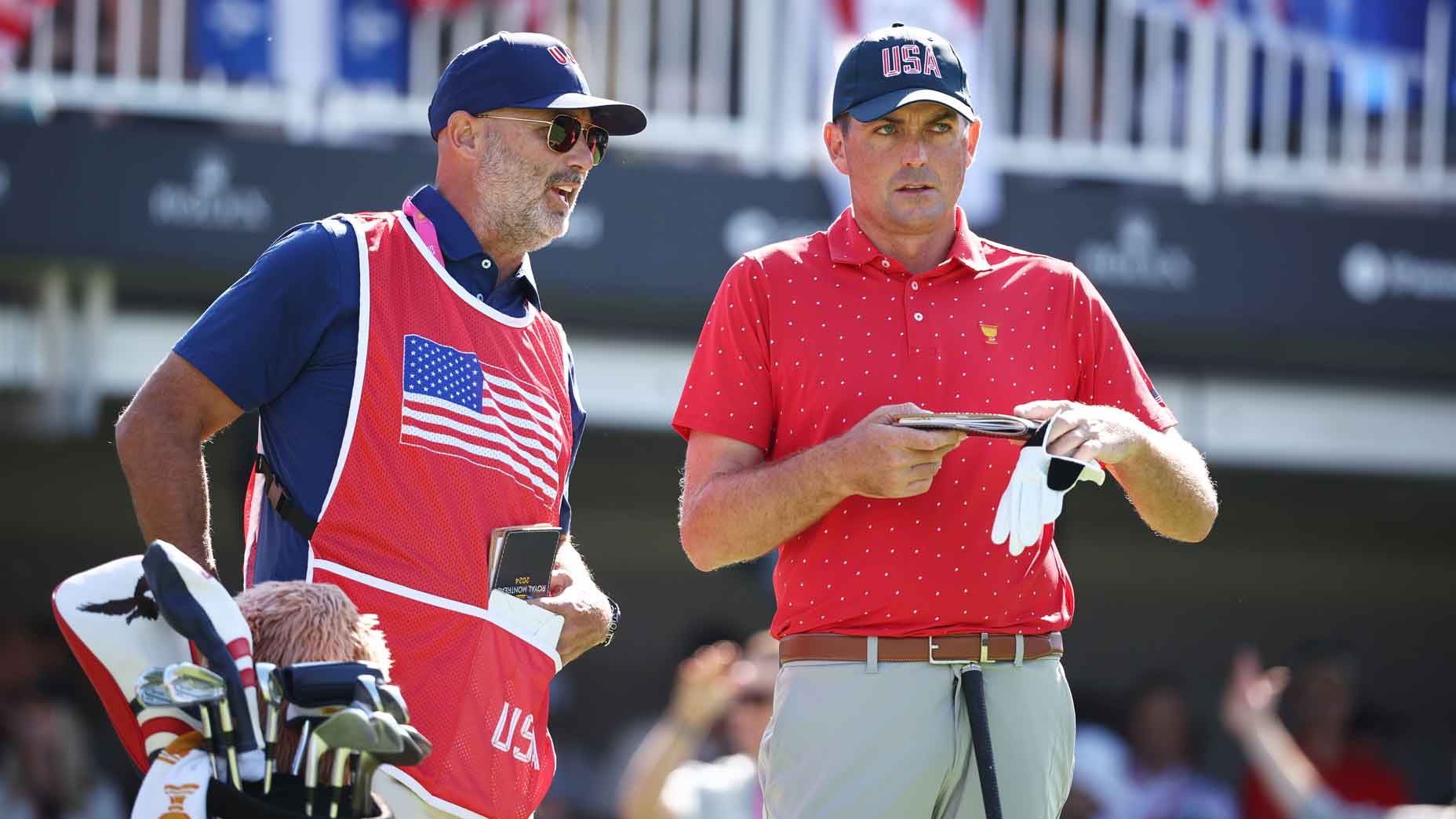 Keegan Bradley talks with his caddie at the Presidents Cup.