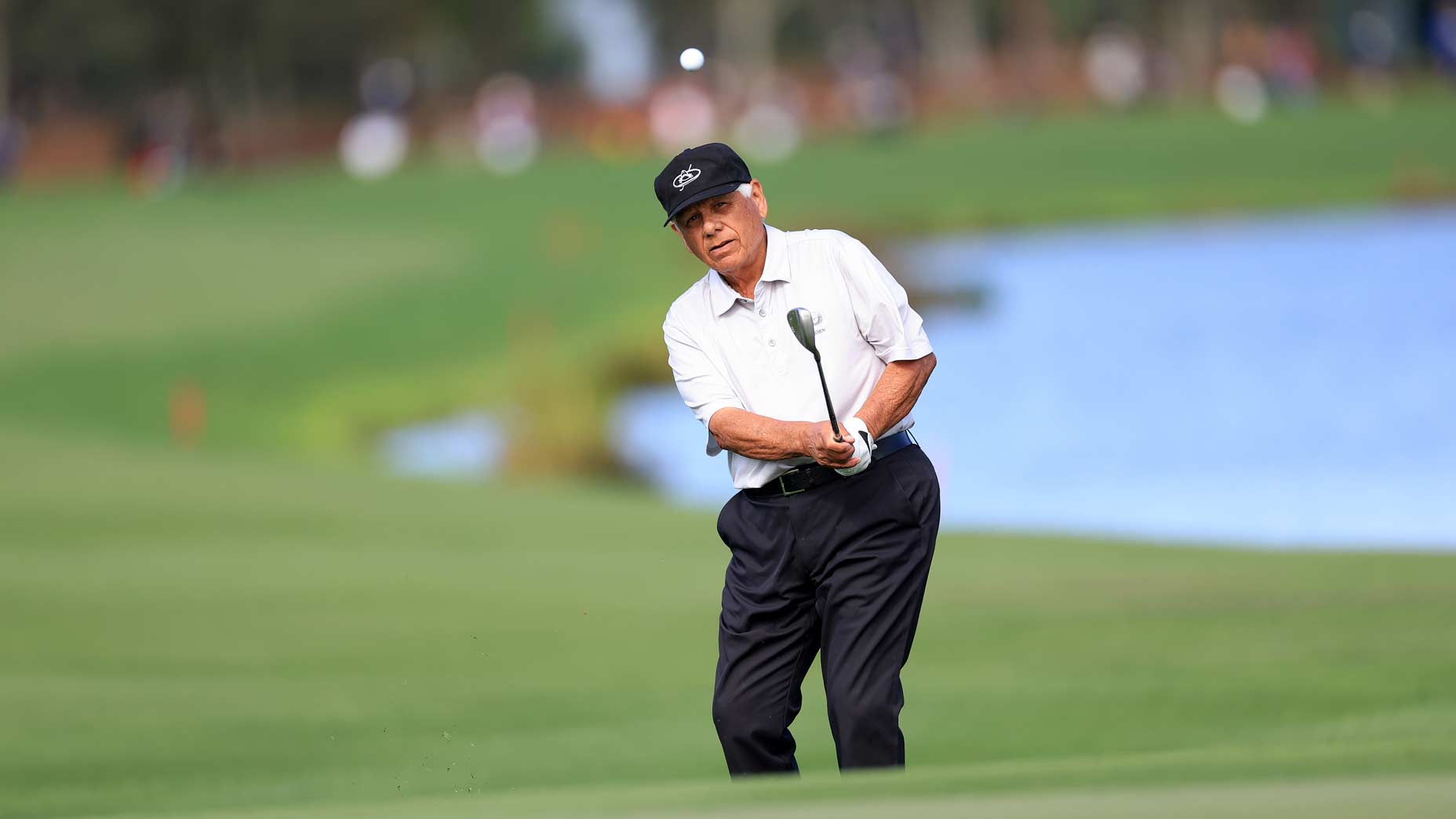 Lee Trevino hits a shot from near the green at the PNC Championship.