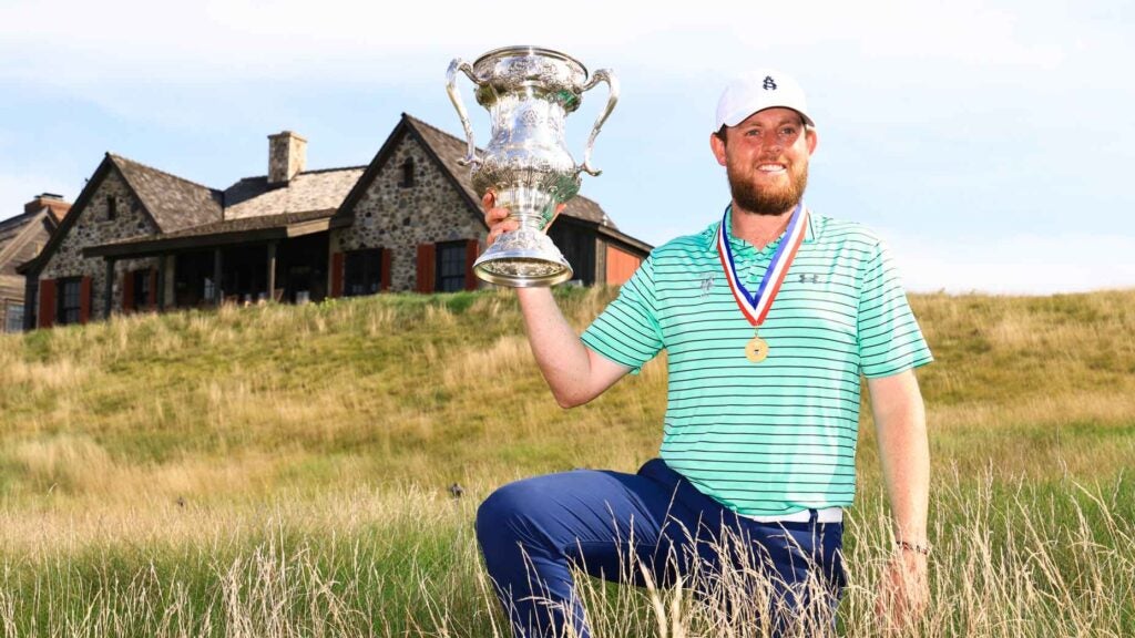 Matthew McClean holds the 2022 U.S. Mid Amateur trophy.