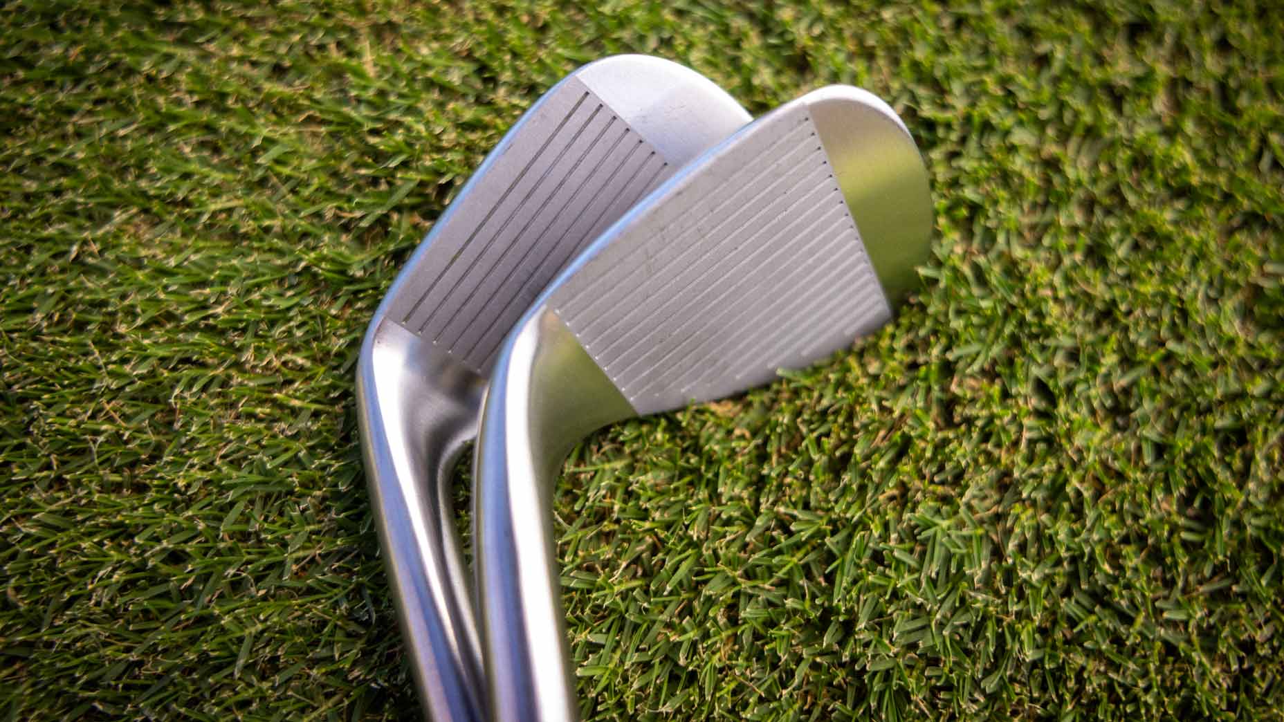 Two of Miura's new forged raw wedges on the grass.