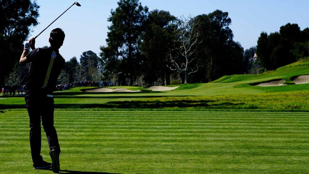 A player hits a tee shot to the 4th hole at Riviera Country Club.