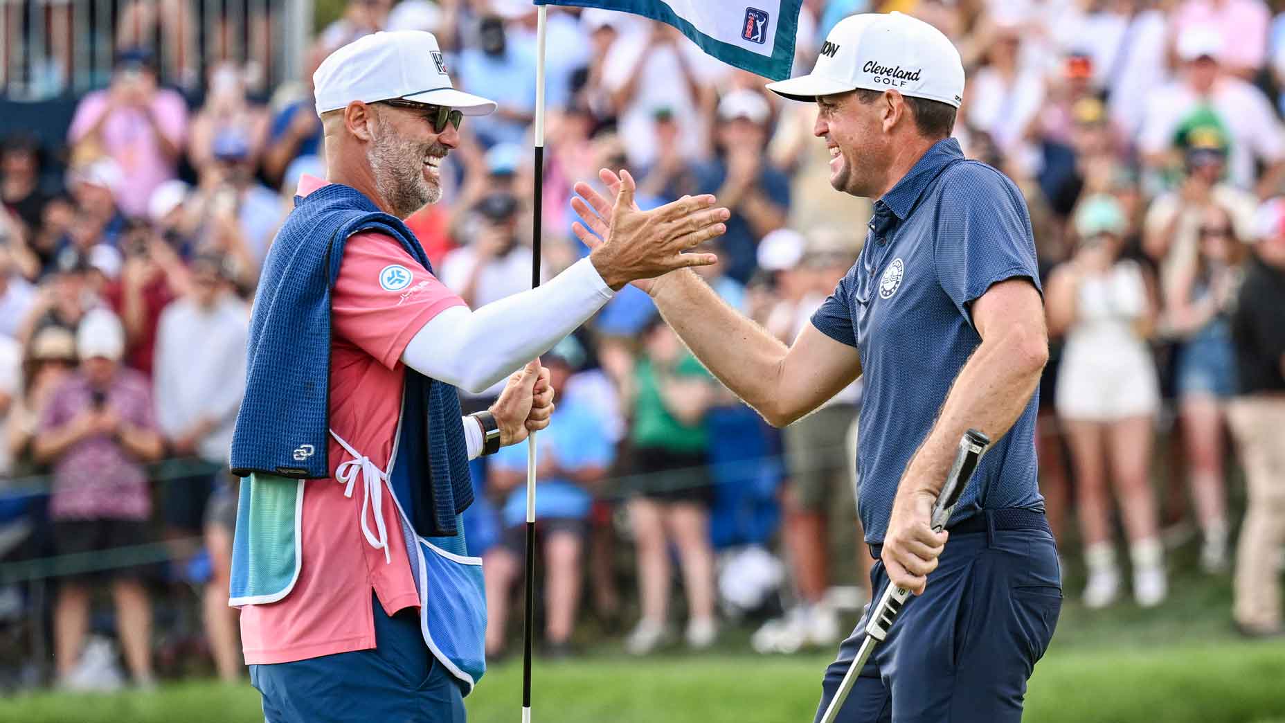 Keegan Bradley celebrates his one stroke victory with caddie Scott Vail on the 18th hole green during the final round of the BMW Championship, the second event of the FedExCup Playoffs, at Castle Pines Golf Club on August 25, 2024 in Castle Rock, Colorado.