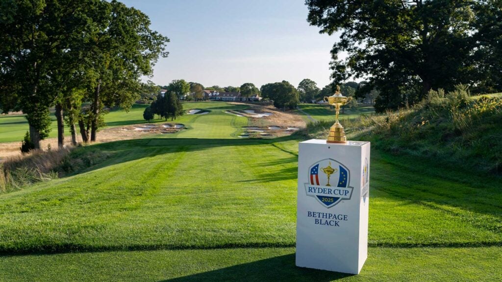 a photo of the ryder cup trophy in front of bethpage black's 18th hole