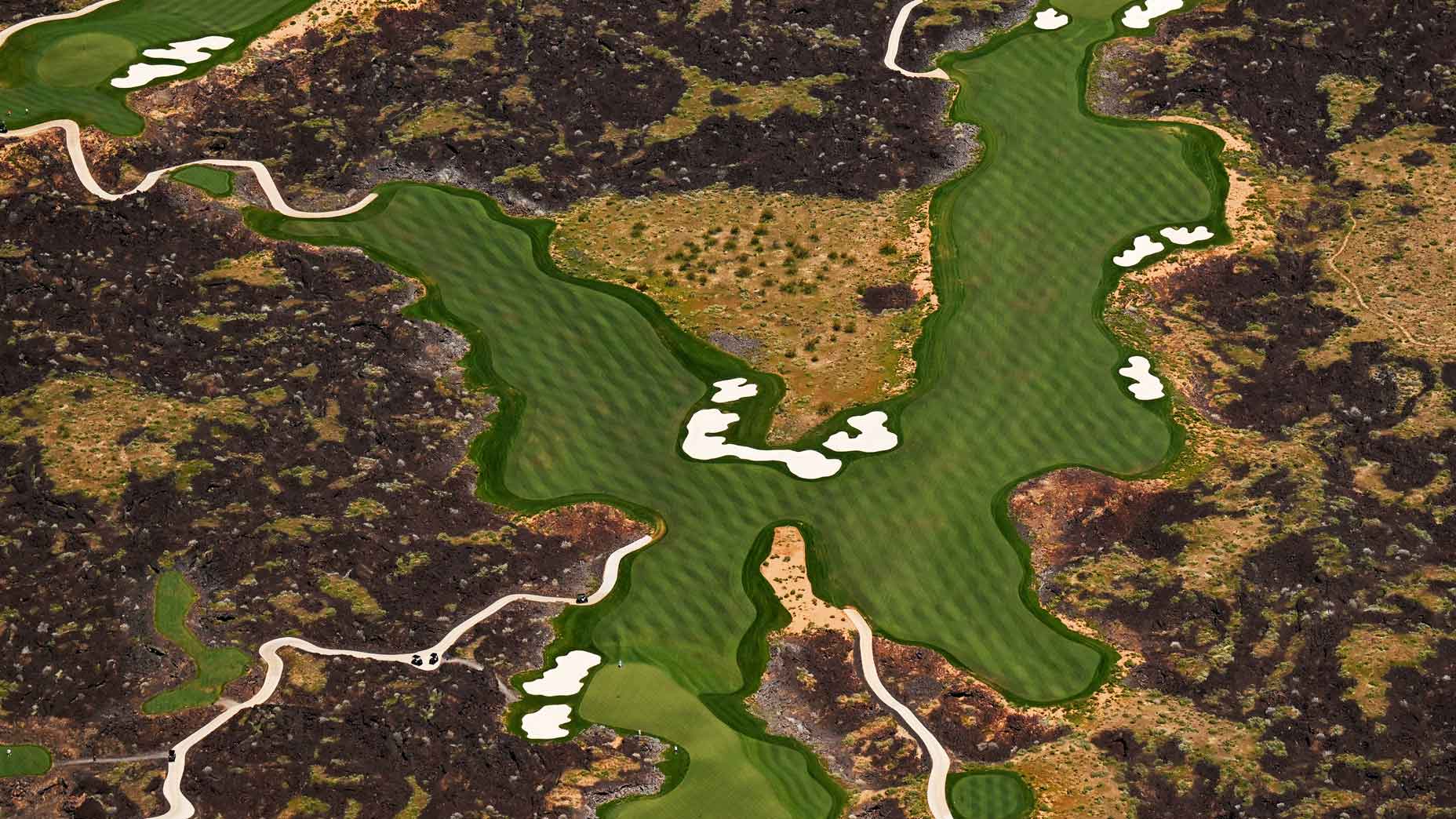 Golfer play at Black Desert Resort golf course on April 15, 2023 in St. George, Utah. The new golf course was built on a hillside covered in black lava rocks. Several homes were also build around the golf course.