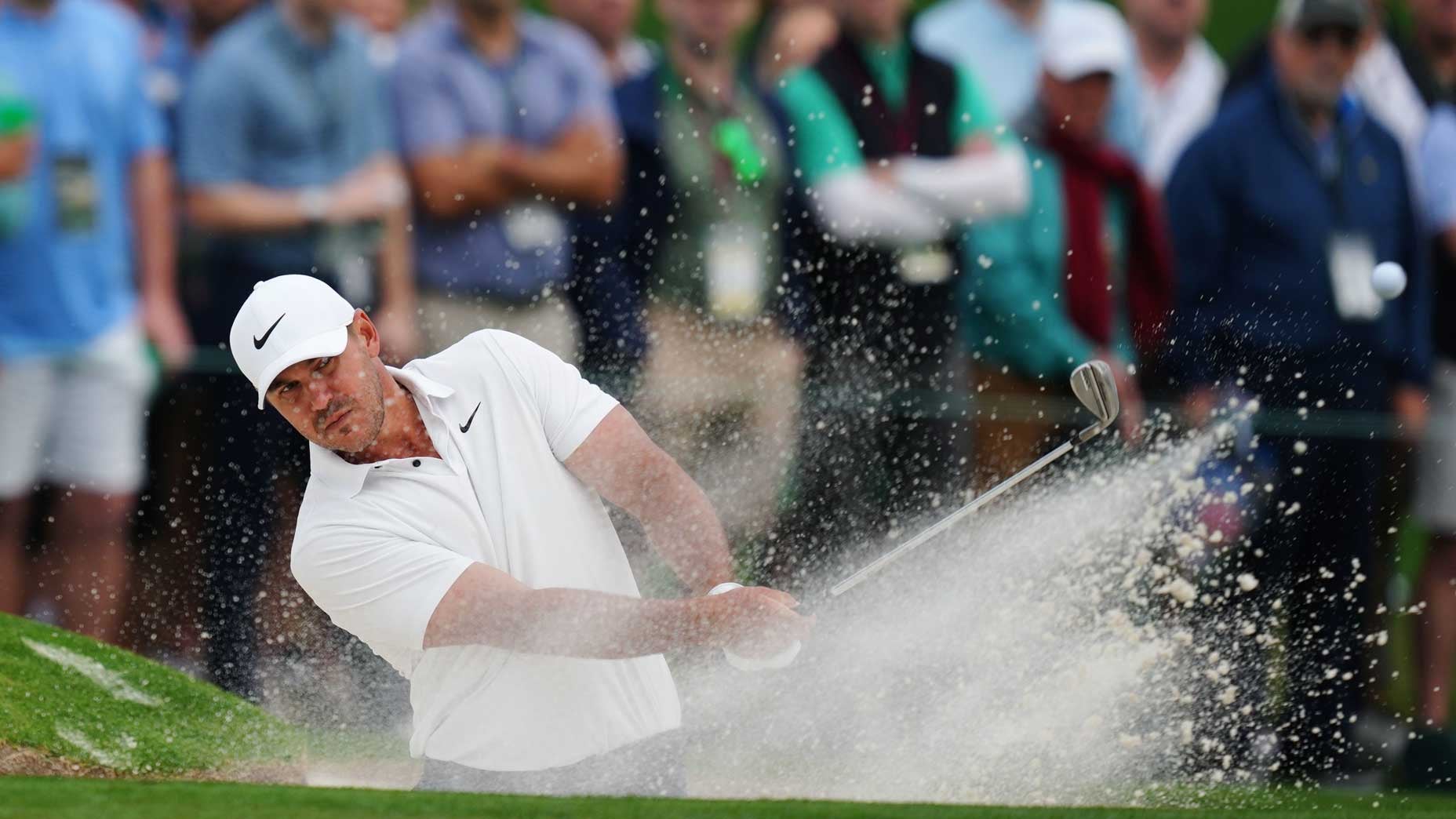 Pro golfer Brooks Koepka hits a bunker shot at Augusta National during the Masters.