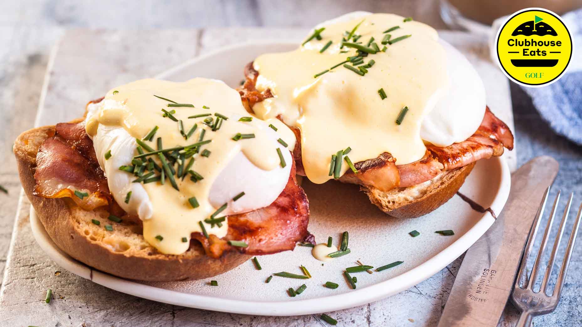 Traditional egg benedict with slices of bacon on toast, poached egg and hollandaise