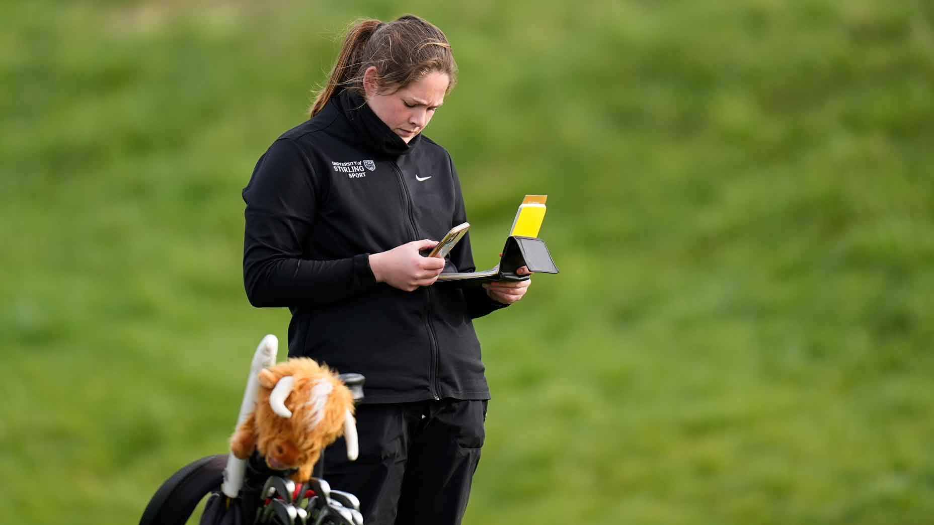 Lorna McClymont from University of Stirling looks at her stats during The R&A Student Tour Series - France at Le Golf National on March 9, 2024, Guyancourt, France.