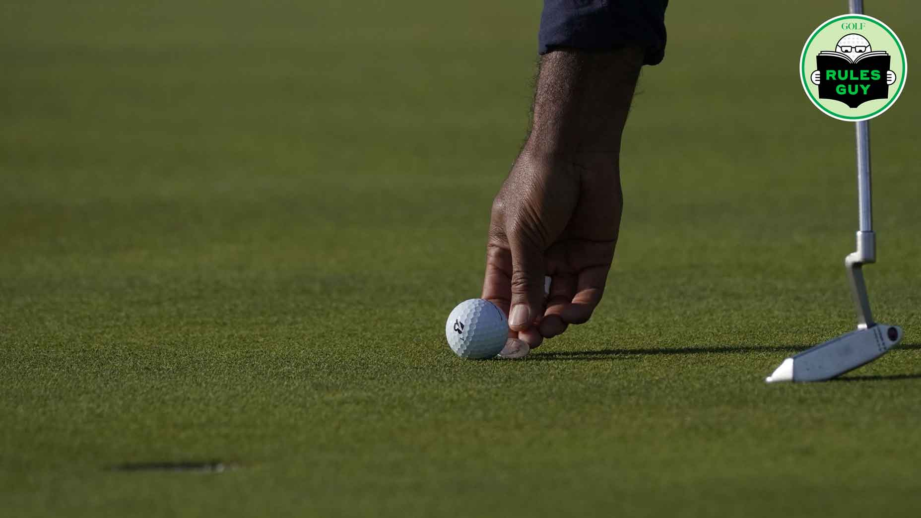 US golfer Tony Finau marks his ball's location during his fourball match on the second day of the 42nd Ryder Cup at Le Golf National Course at Saint-Quentin-en-Yvelines, south-west of Paris, on September 29, 2018.