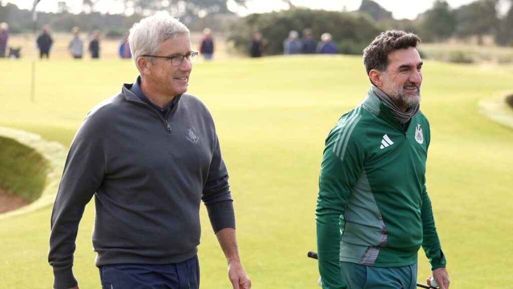 jay monahan and yasir al-rumayyan walk at the alfred dunhill links championship