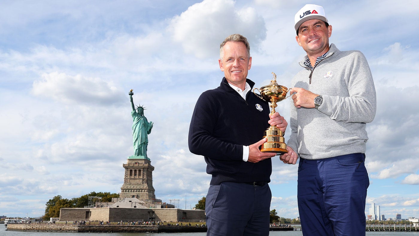 Team Captains Luke Donald of England and Keegan Bradley of The United States pose for a photograph with the Ryder Cup Trophy near Statue of Liberty