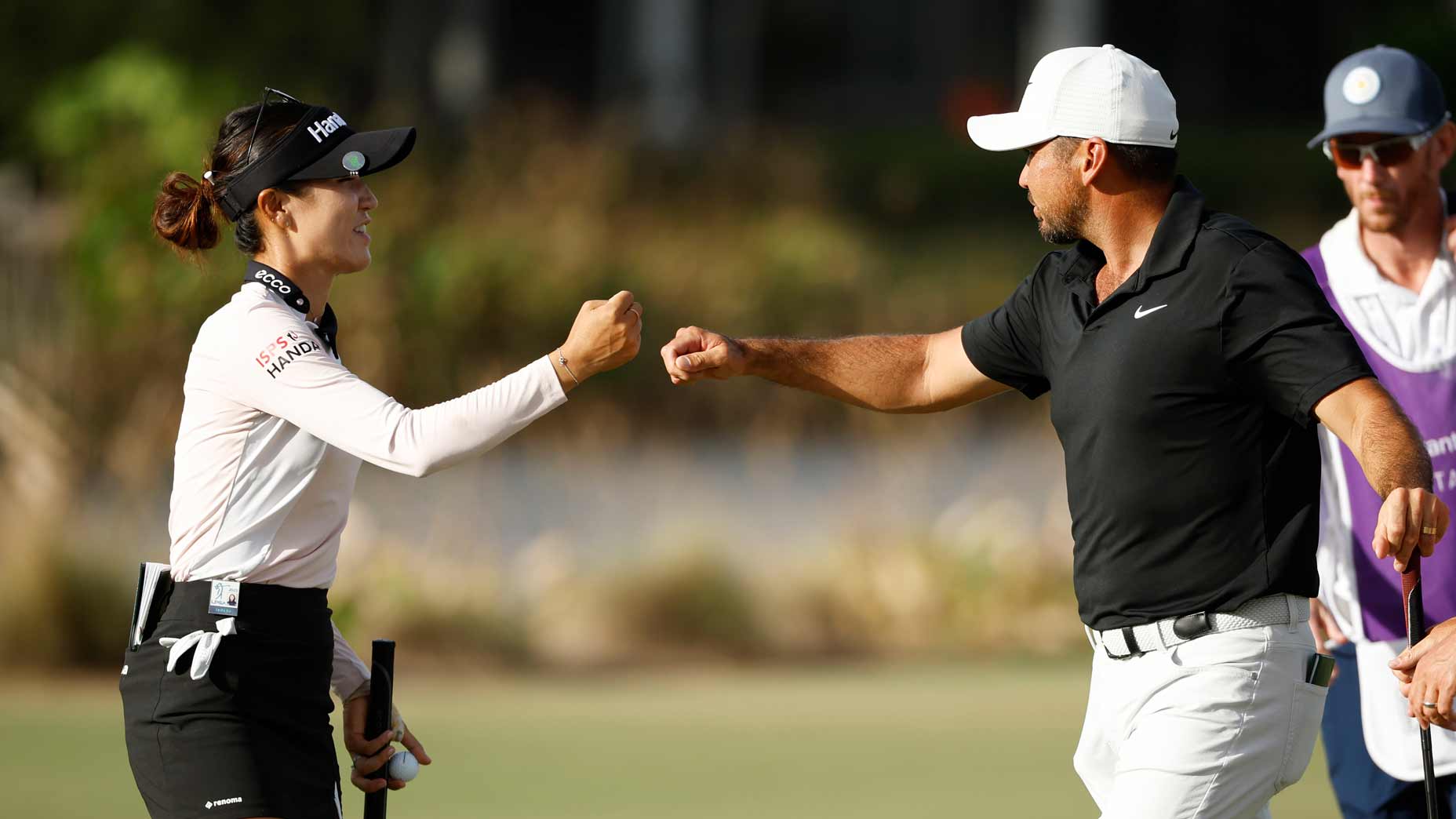 Lydia Ko and Jason Day fist-bump after putt at the 2023 Grant Thornton Invitational.