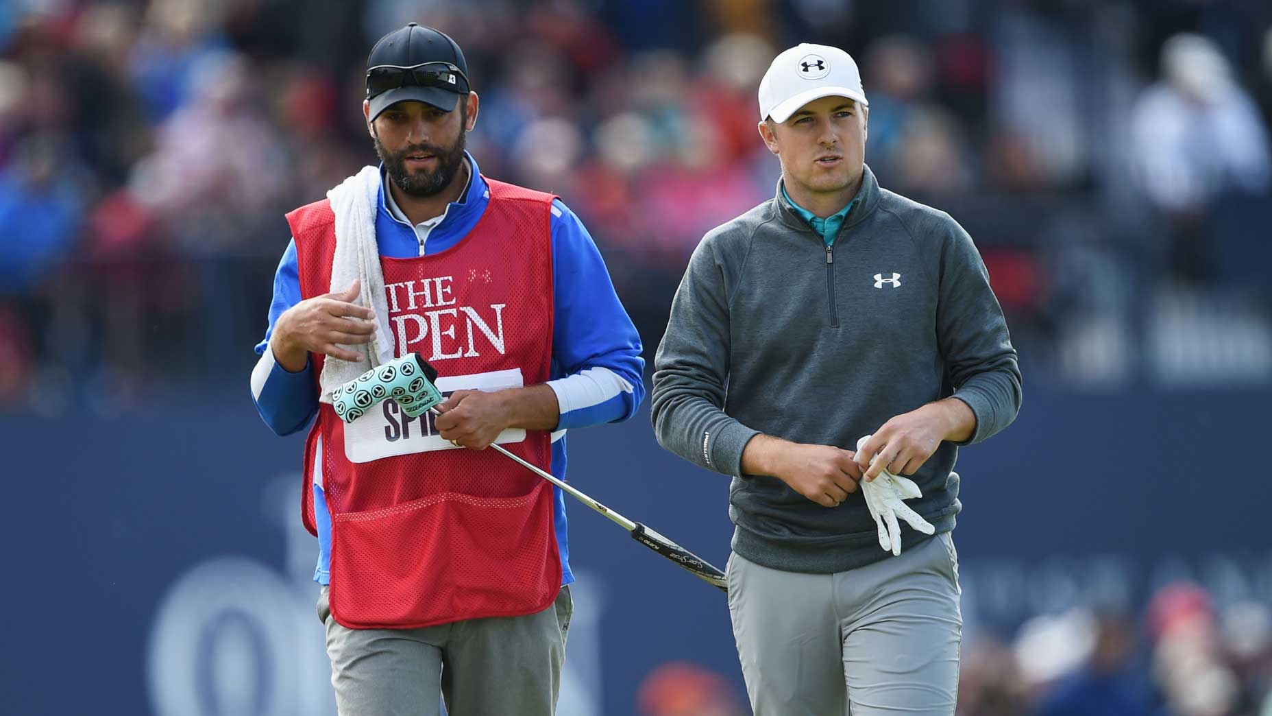 PGA Tour pro Jordan Spieth and caddie Michael Greller look on from the 18th tee during the third round of the 144th Open Championship.