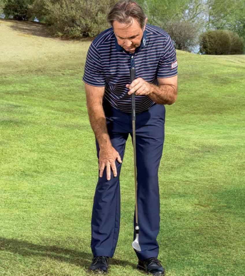 shawn callahan stands with a cane dangling in front of him