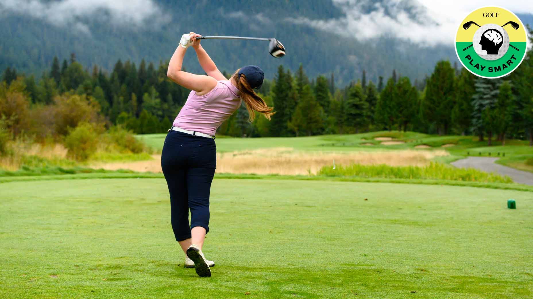 female golfer hits drive on golf course