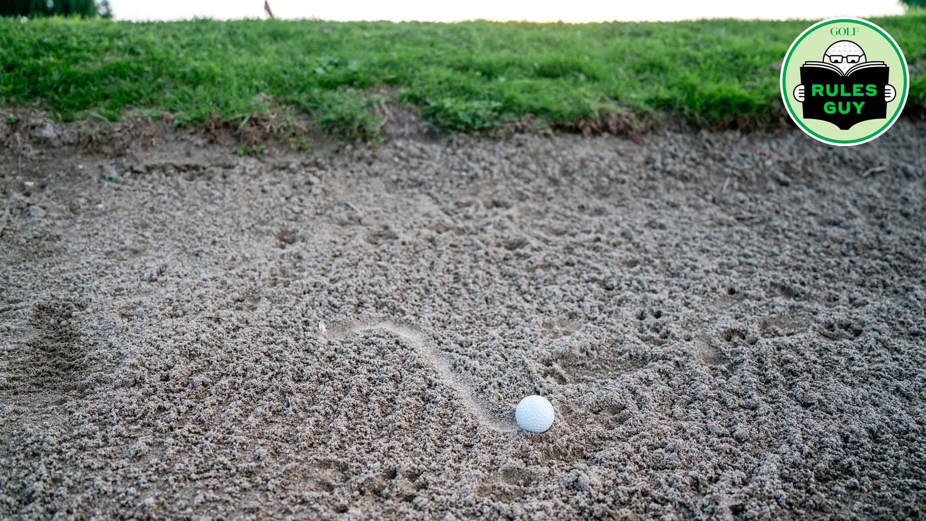 Golf ball in the sand trap. No people.