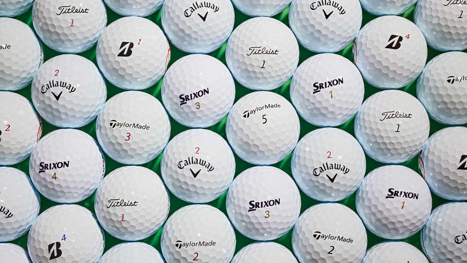 Golf balls arranged on green background