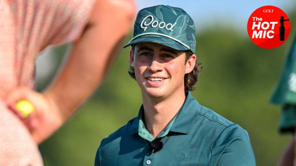 garrett clark smiles in a green hat with the 'good' logo on it and a matching green shirt