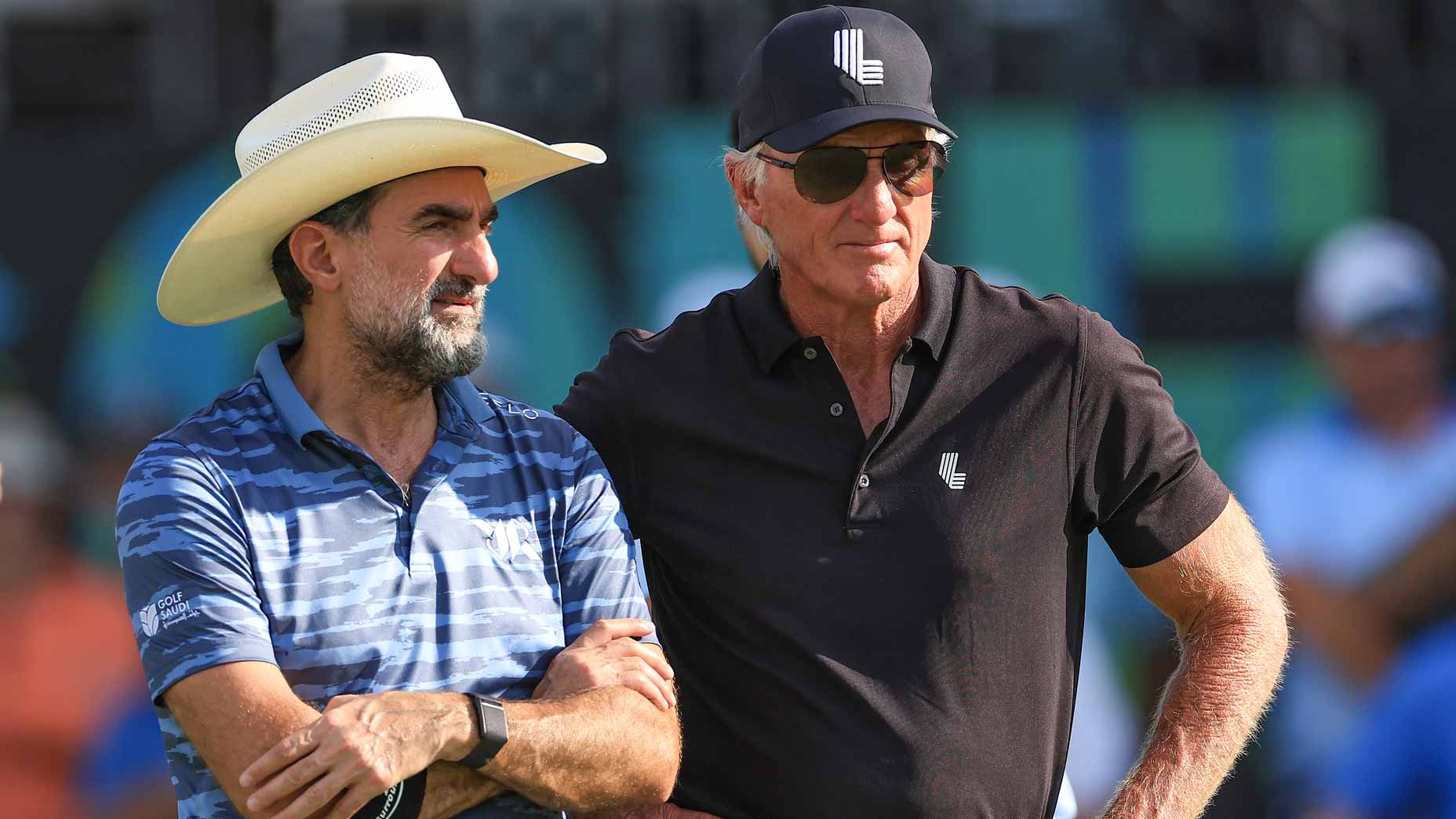 Yasir Al-Rumayyan with Greg Norman watch the closing stages on the 18th green during the individual team stroke-play finals on day three of the LIV Golf Team Championship Dallas.