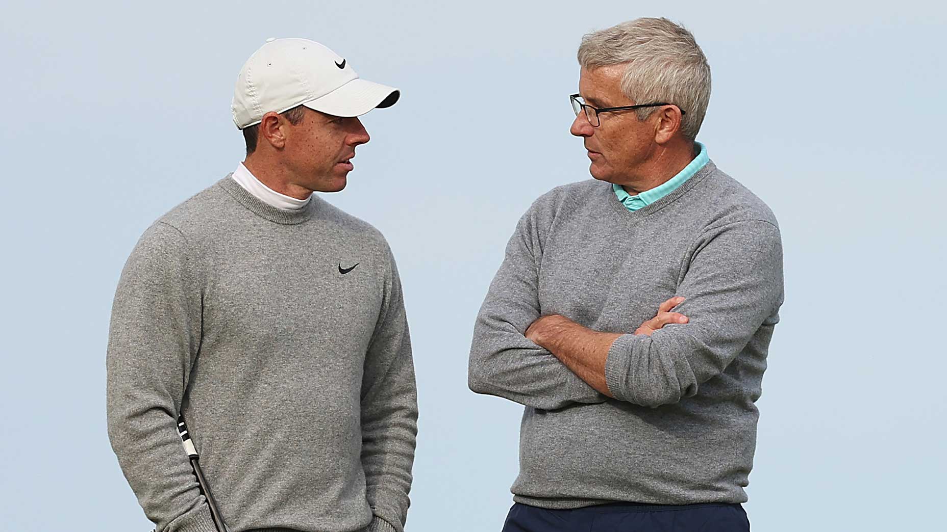 jay monahan and rory mcilroy speak to one another in gray sweaters