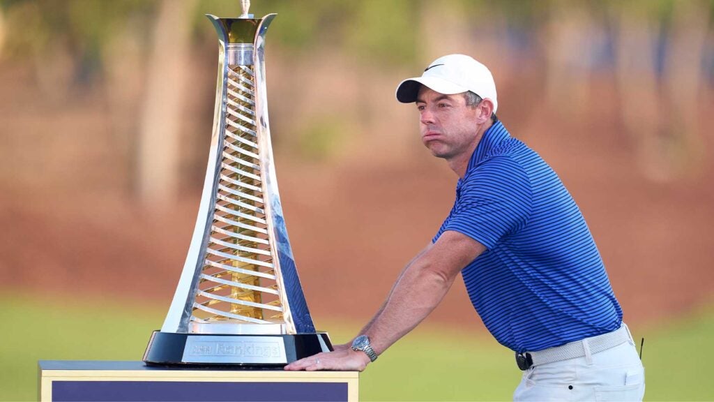 rory mcilroy cries in front of trophy in blue shirt at dp world tour championship