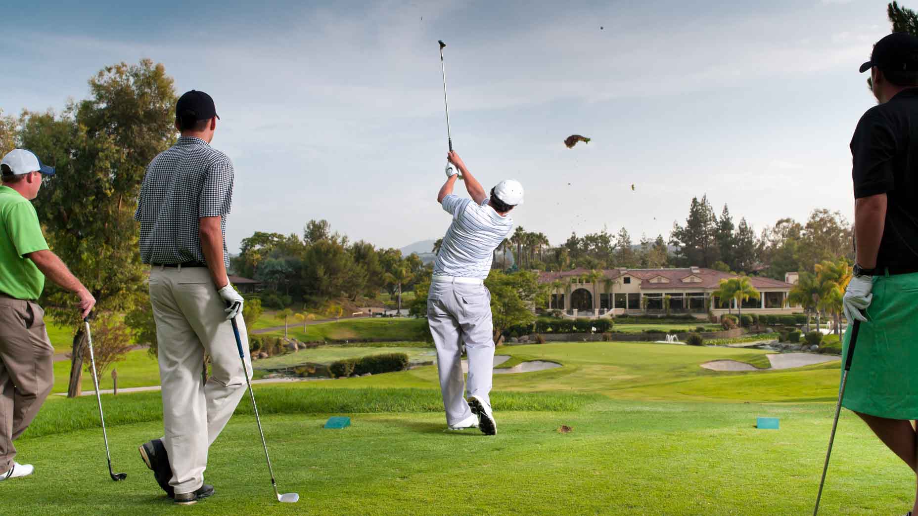 Golfer hits a tee shot on a par 3