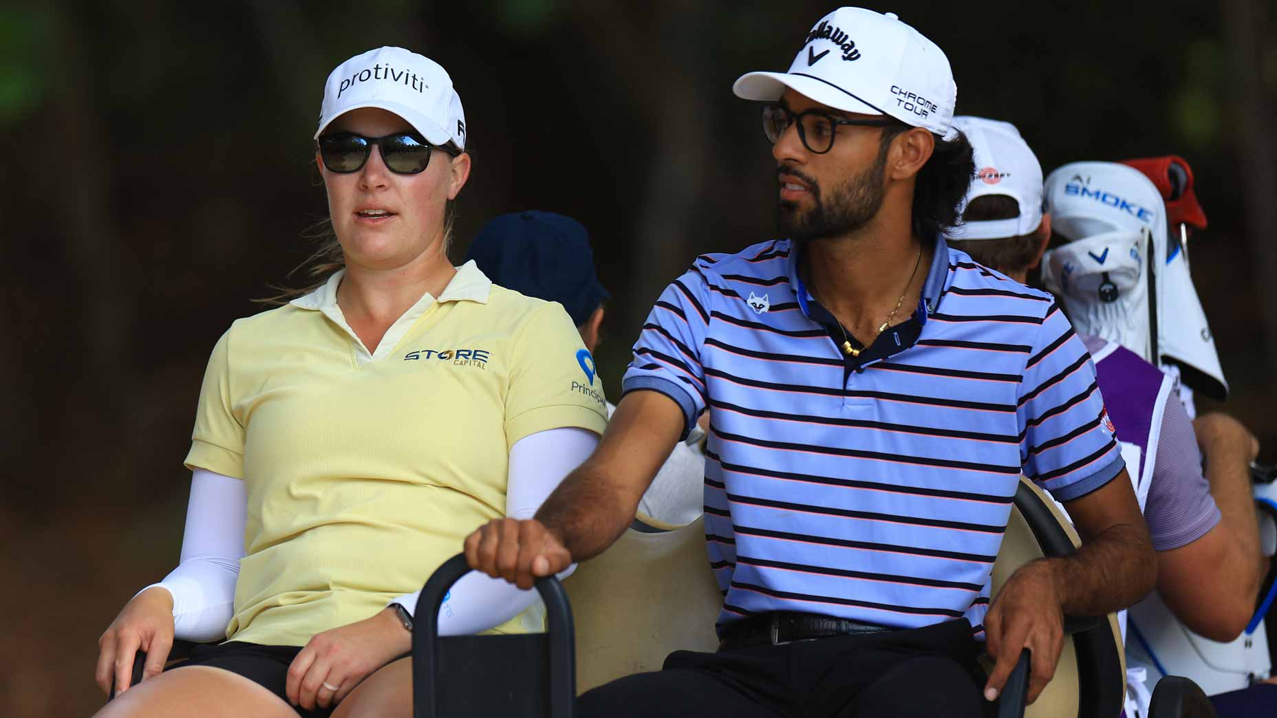 LPGA pro Jennifer Kupcho and PGA Tour pro Akshay Bhatia ride in a cart to the fourth tee during the first round of the 2024 Grant Thornton Invitational at Tiburon Golf Club.