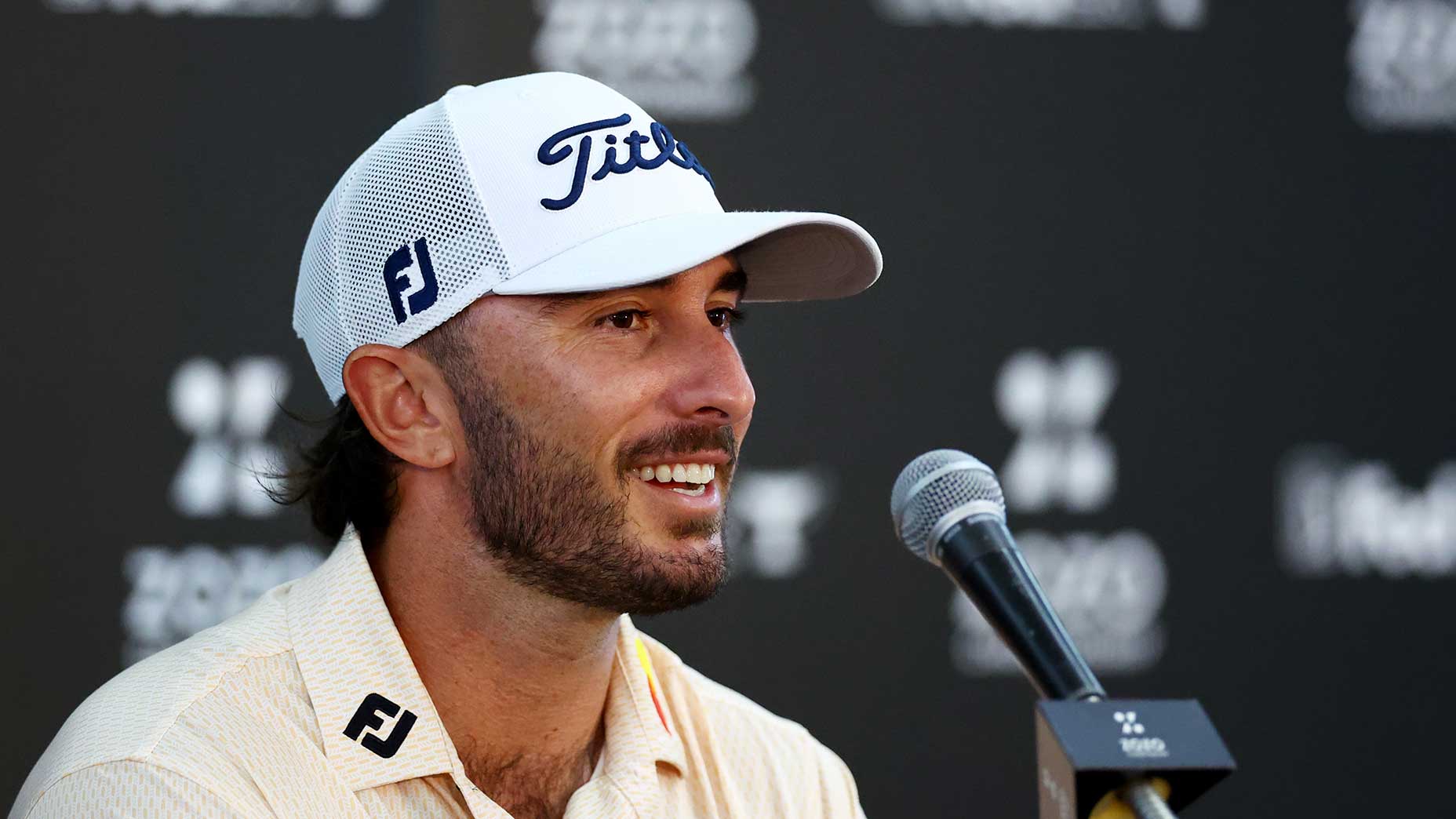 Max Homa speaks to the media during a press conference.