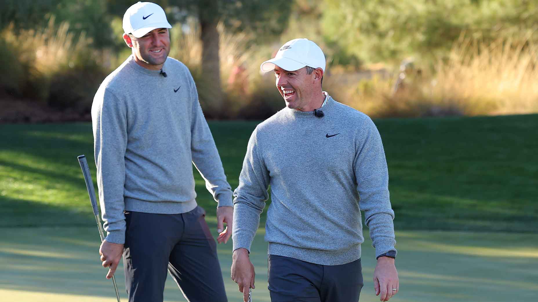 rory mcilroy and scottie scheffler smile at the Showdown in Las Vegas at Shadow Creek Golf Club.