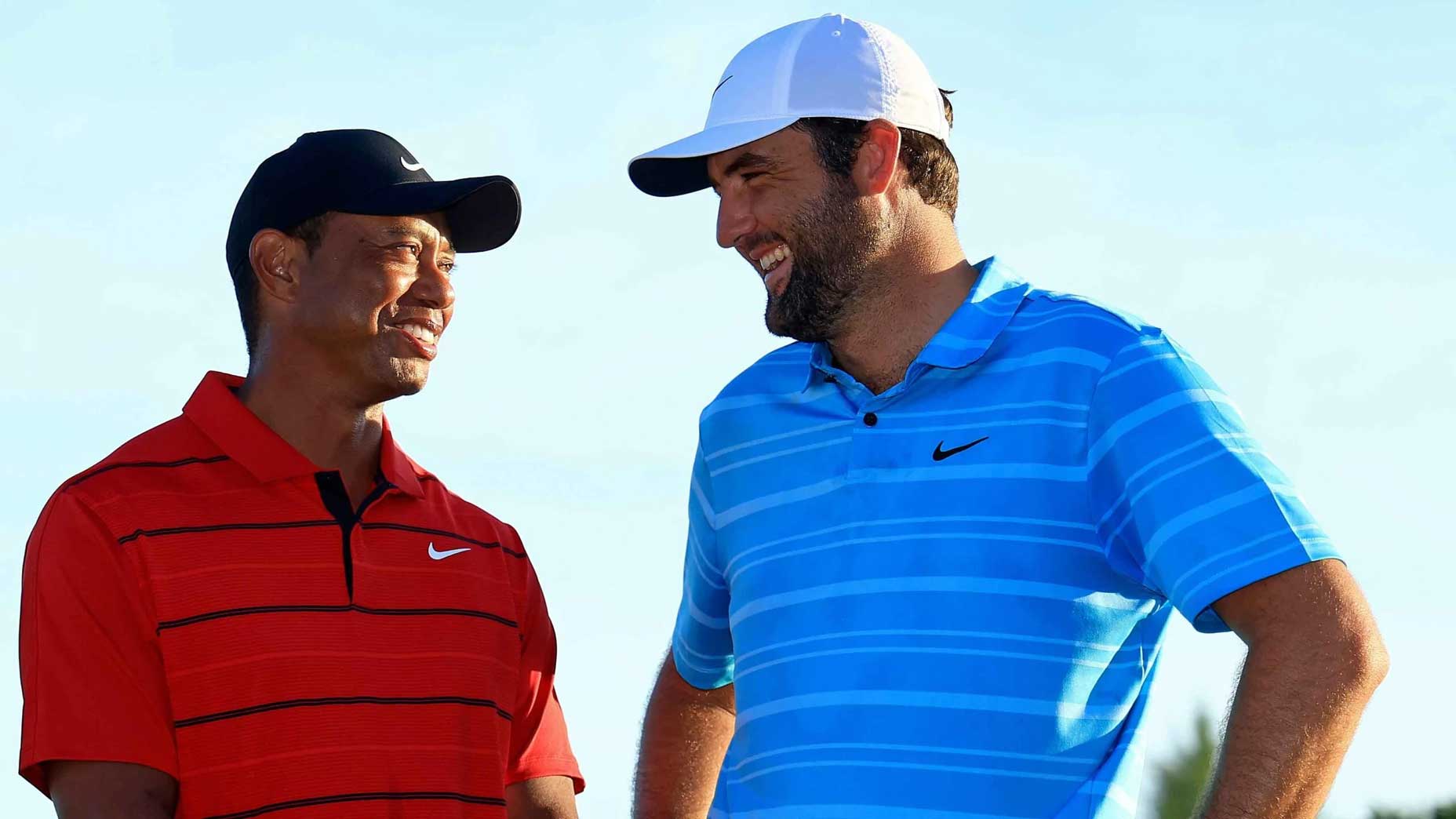 Pro golfer Scottie Scheffler beside the Hero World Challenge Trophy with tournament host Tiger Woods.