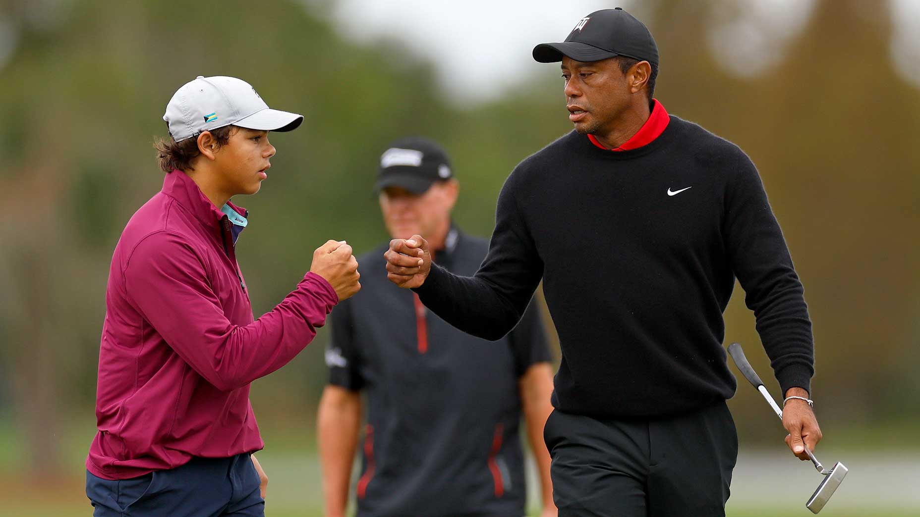 Tiger Woods and Charlie Woods bump fists during the final round of the 2023 PNC Championship at The Ritz-Carlton Golf Club.