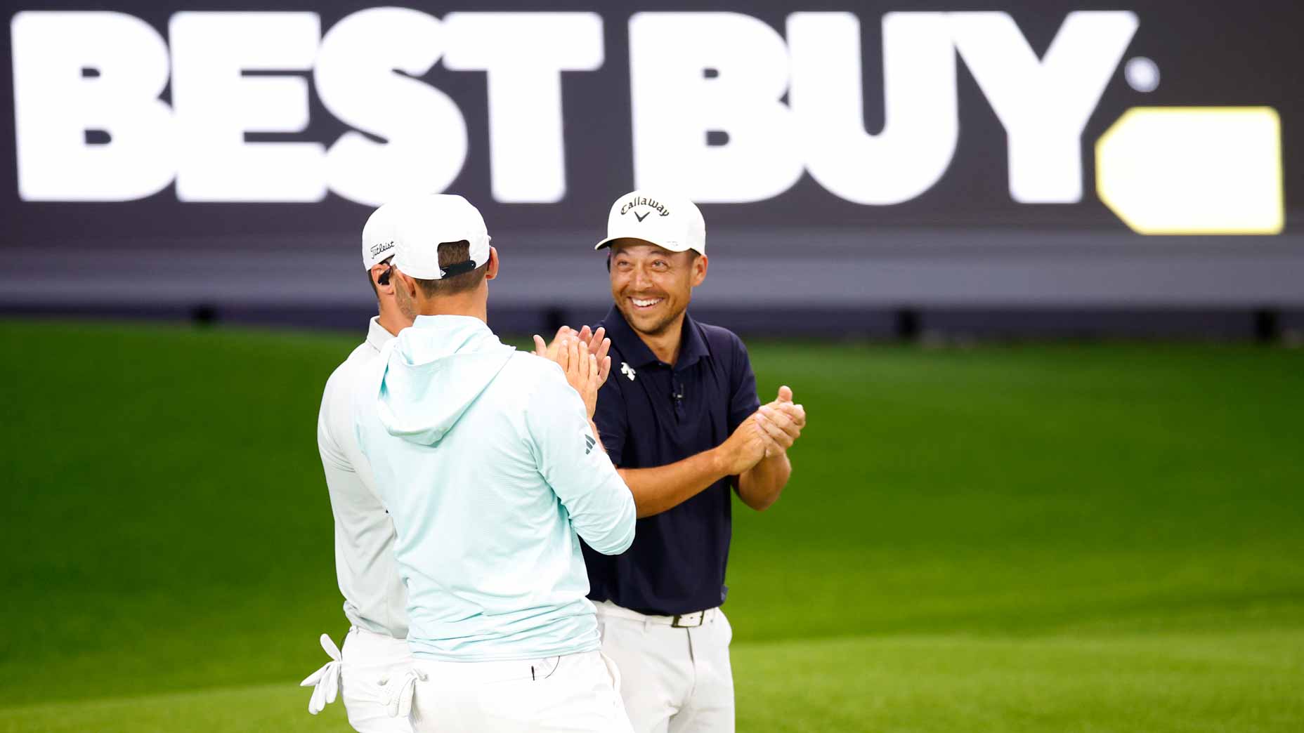 Xander Schauffele talks with Ludvig Aberg and Wyndham Clark during TGL's opening night.