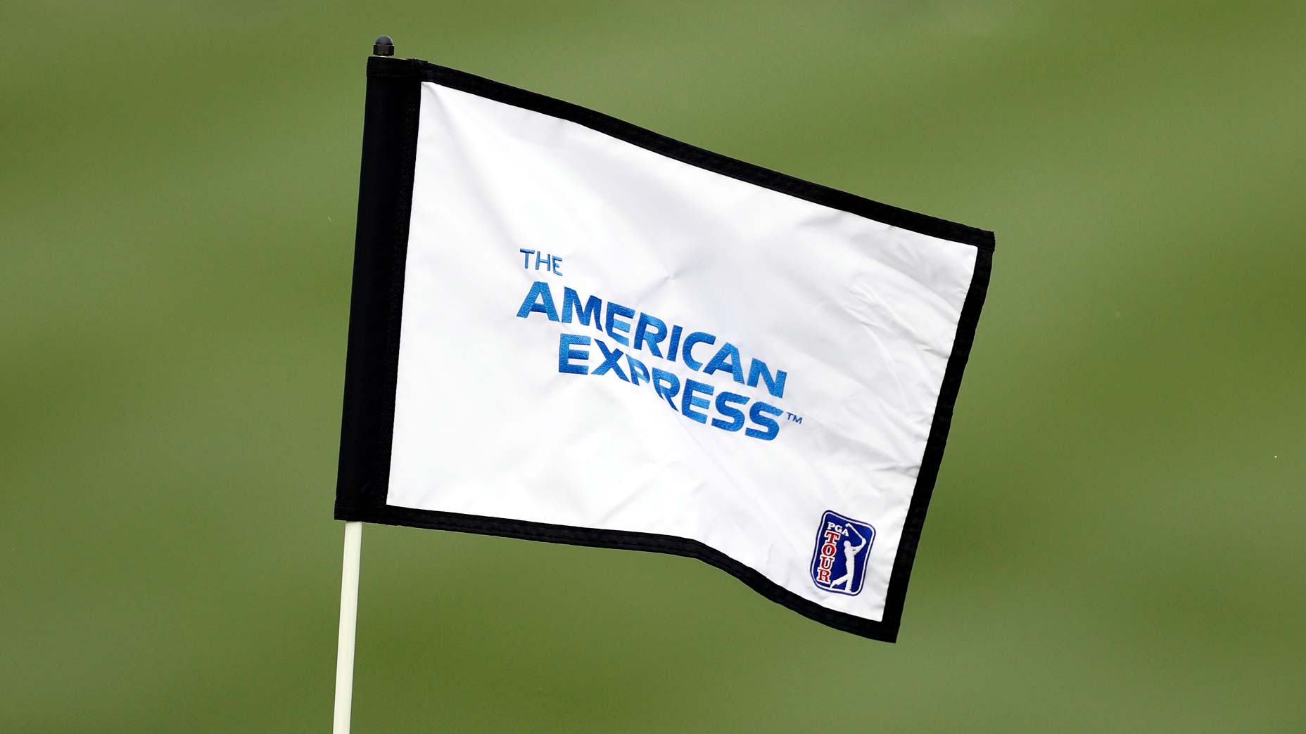 The 2025 PGA Tour American Express logo is seen on the flag of a hole setter during the second round of The American Express at the Jack Nicklaus Tournament Course at PGA West.