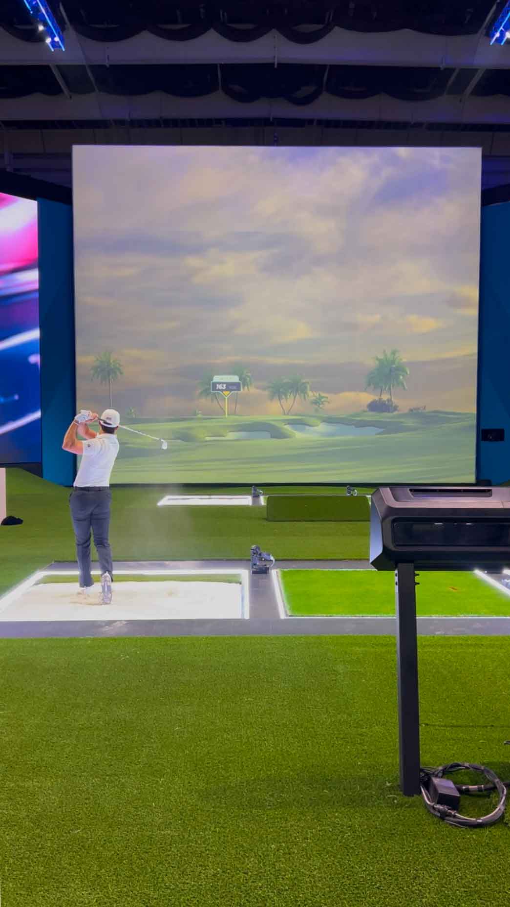 Billy Horschel hits a shot into the TGL's simulator screen.