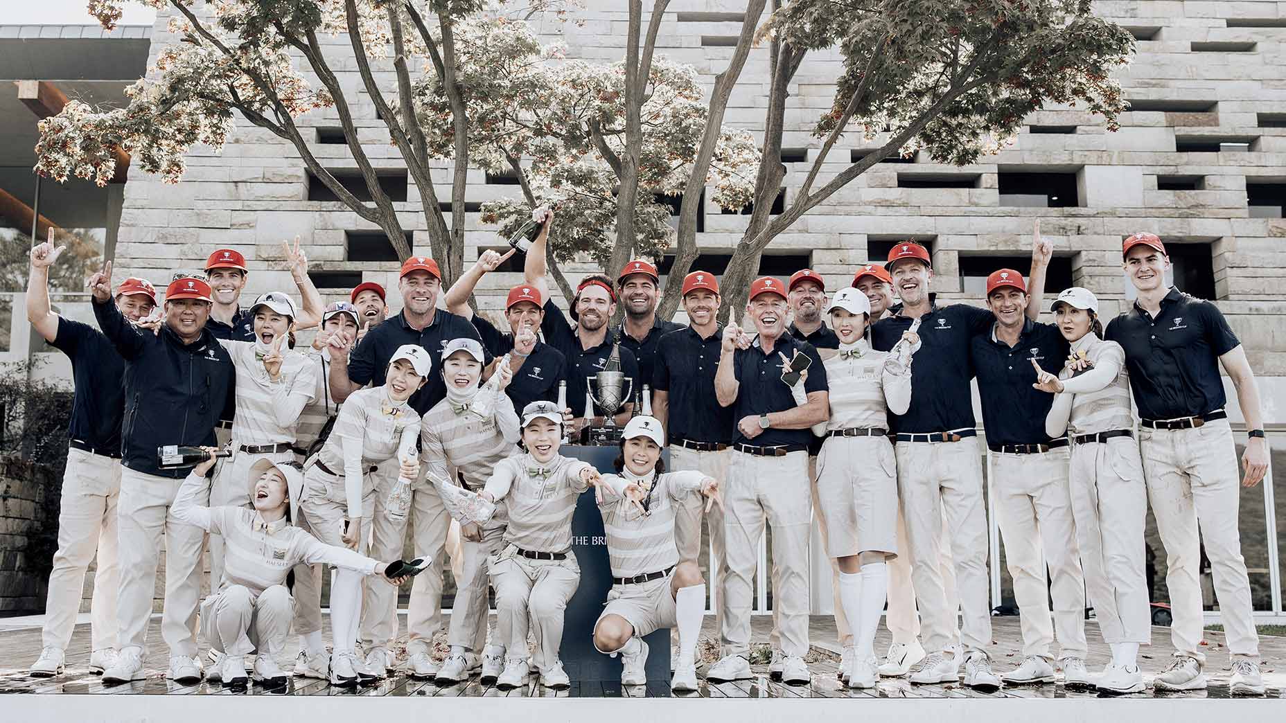 U.S. captain Jeff Fujimoto (front left), flanked by teammates and their local caddies, celebrate a third straight Bridges Cup victory for the Americans.