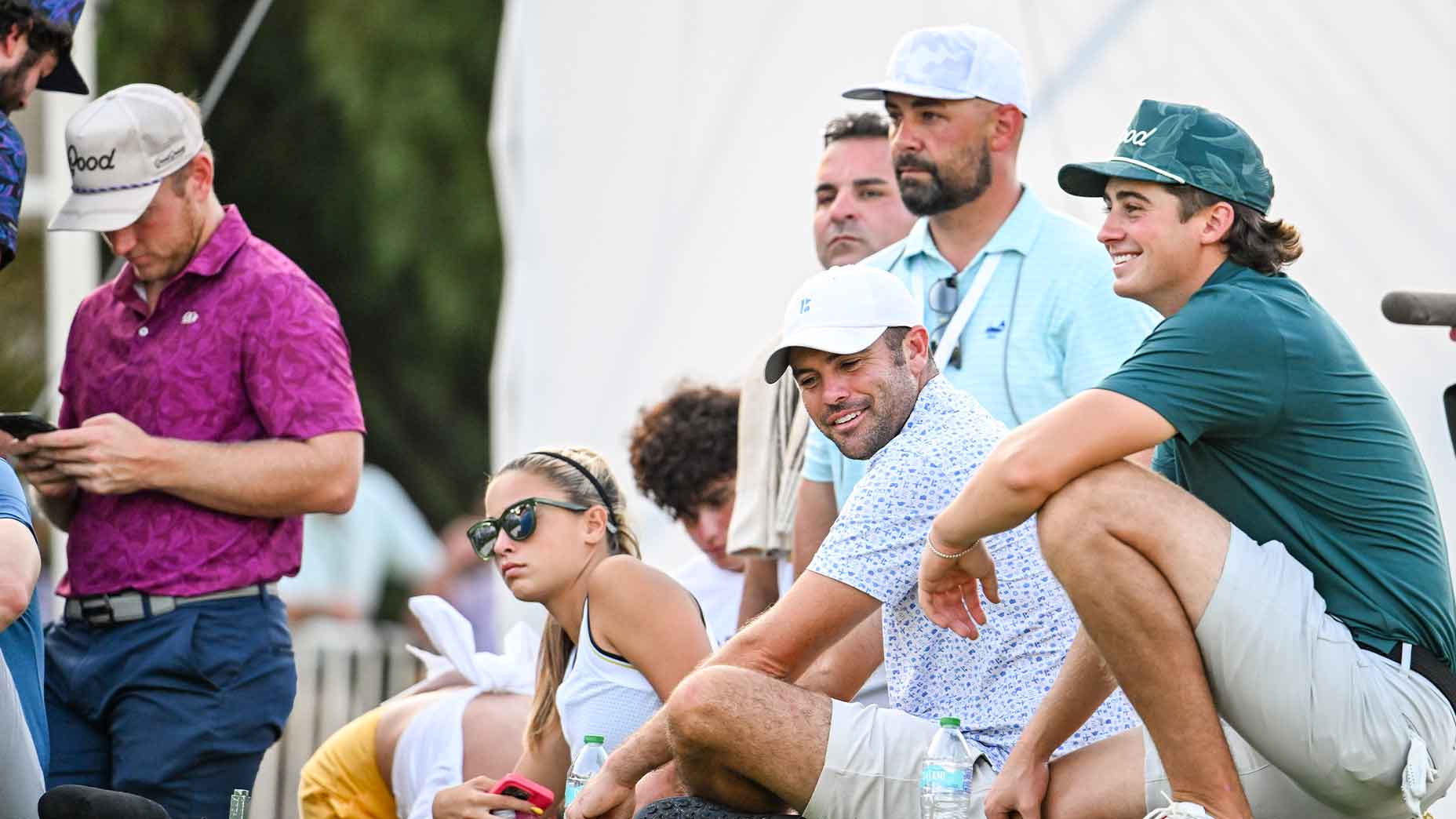 several golf influencers huddle together during the playing of the 2024 creator classic.