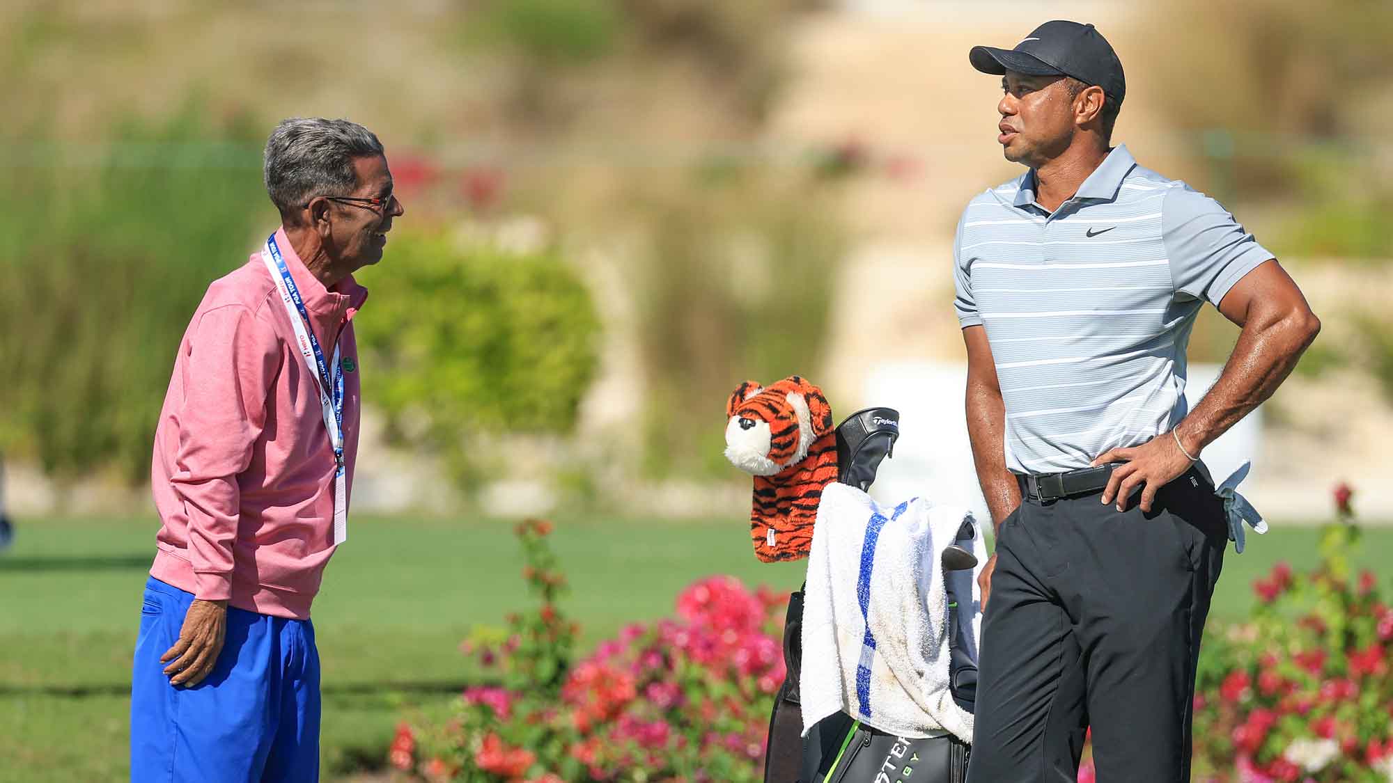 Tiger Woods of The United States talks with American golf writer Steve DiMeglio on the range as a preview for the Hero World Challenge