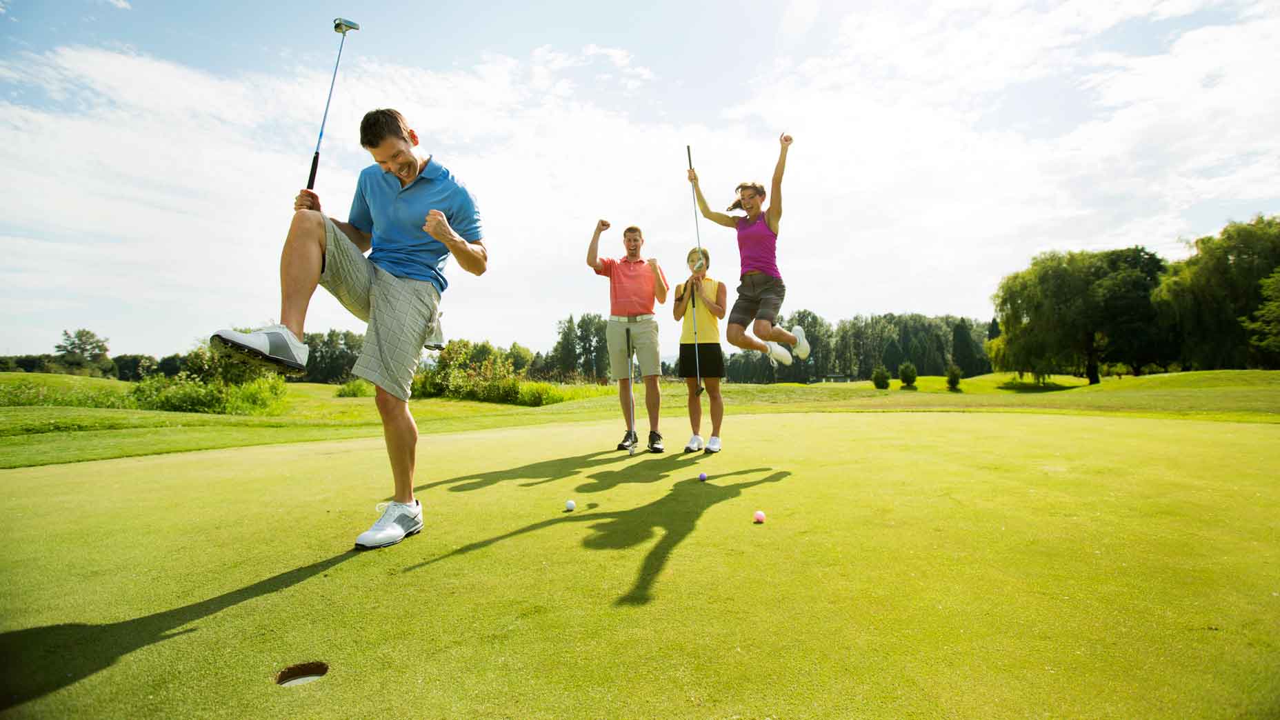 golfers celebrate on putting green