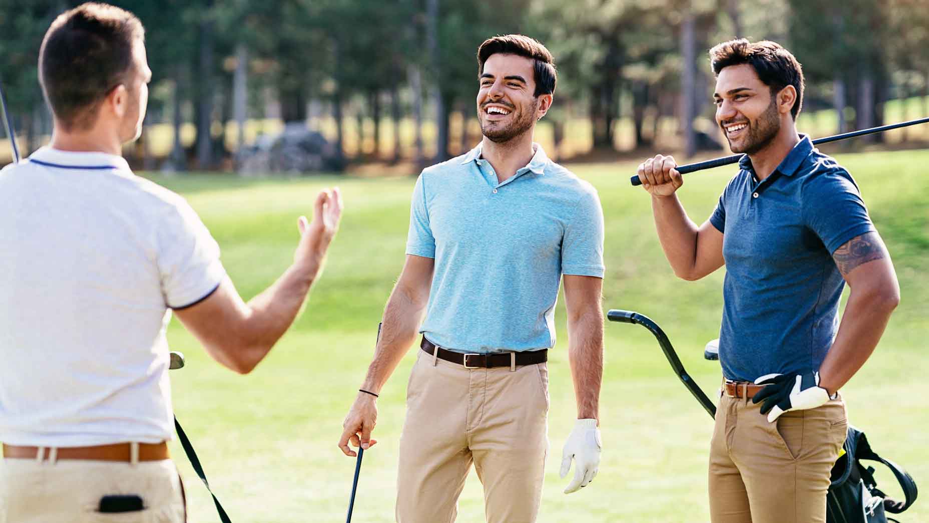 Multi-ethnic group of young men talking on a golf field