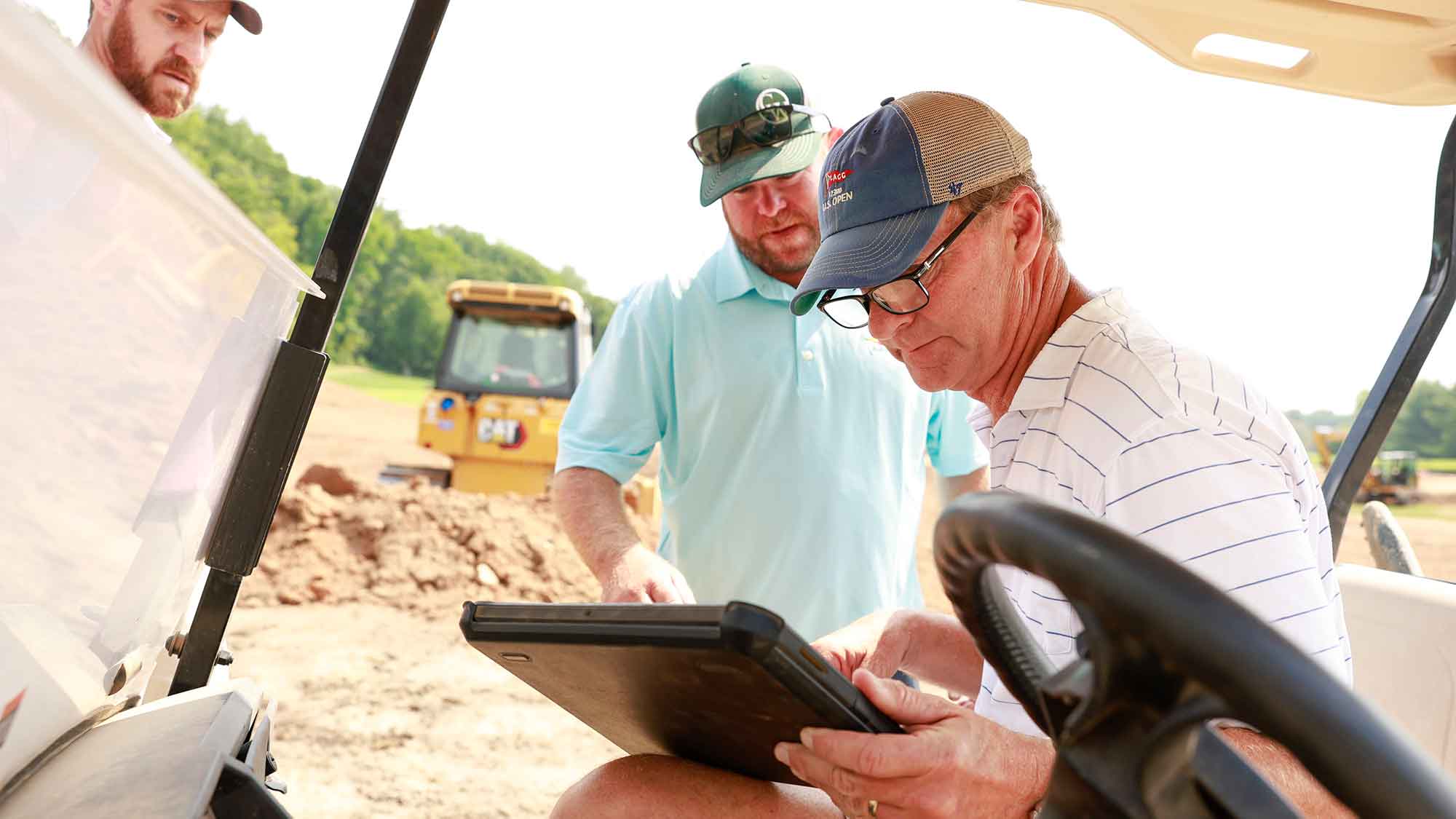 Kevin Murphy, left, design associate, Hanse Golf Course Design and Shaymus Maley, a shaper at Caveman Construction, consult with Gil Hanse, right, president and lead designer at Hanse Golf Course Design, at the Upper Course 14th hole location at Baltusrol Golf Club