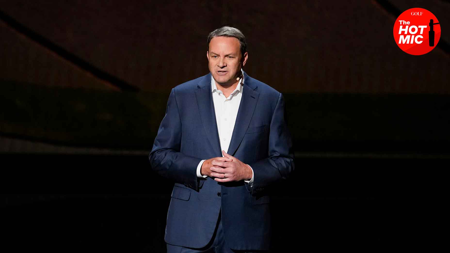 mark lazarus speaks at NBC upfront in navy suit jacket and white shirt with hands folded