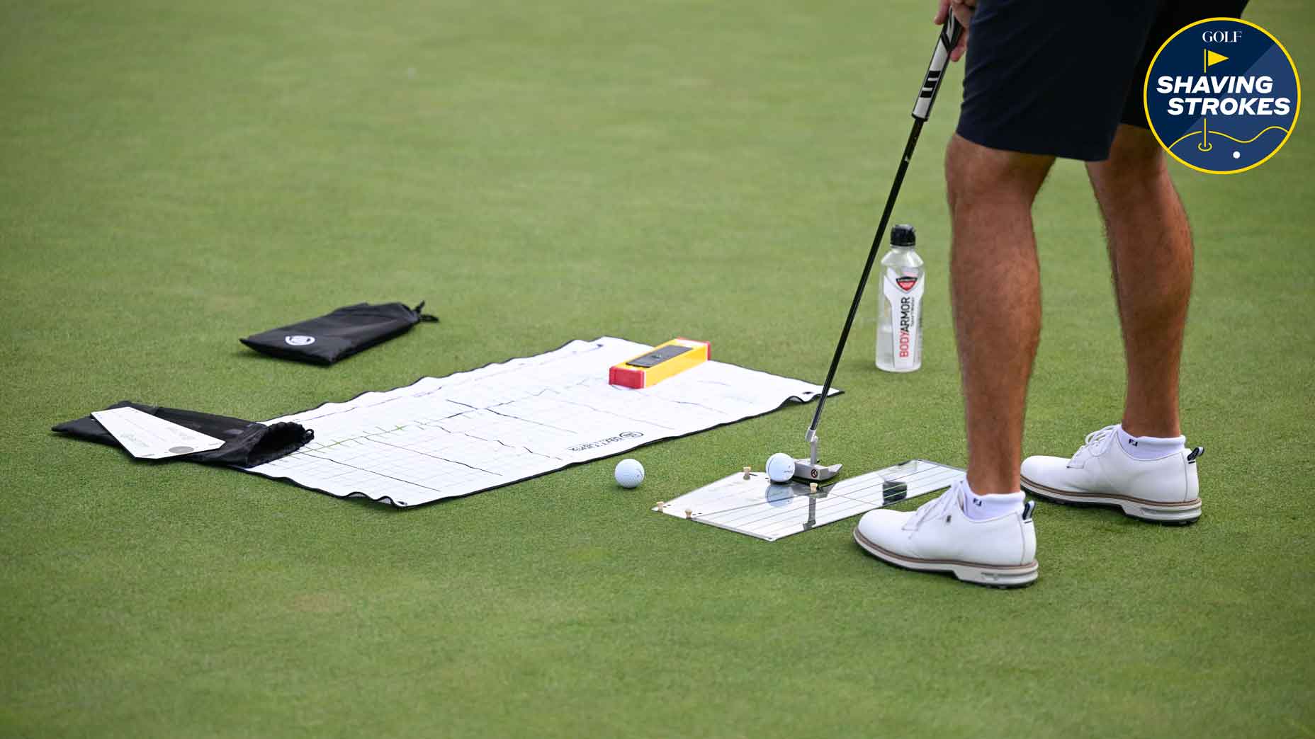 golfer practices putting drill with putting mirror