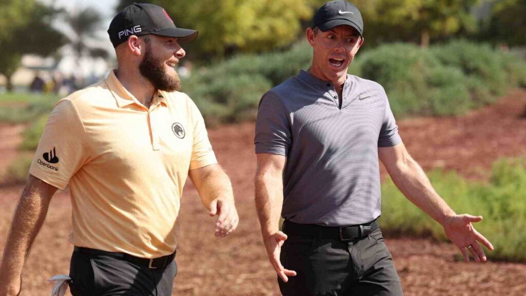 Rory McIlroy talks with Tyrrell Hatton during the first round of the DP World Tour Championship.