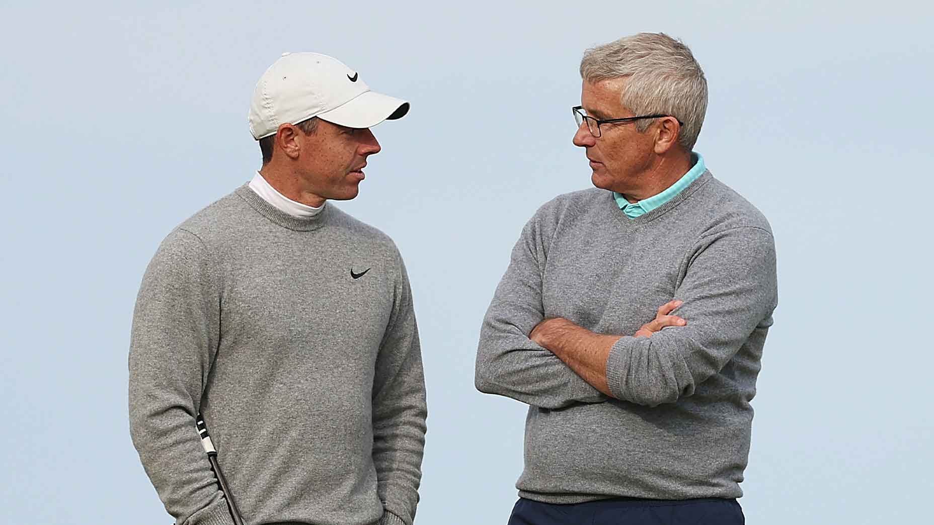 Jay Monahan talks to Rory Mcilroy with the wrapped hands in Srey Sweater in Alfred Dunhill Links Championship