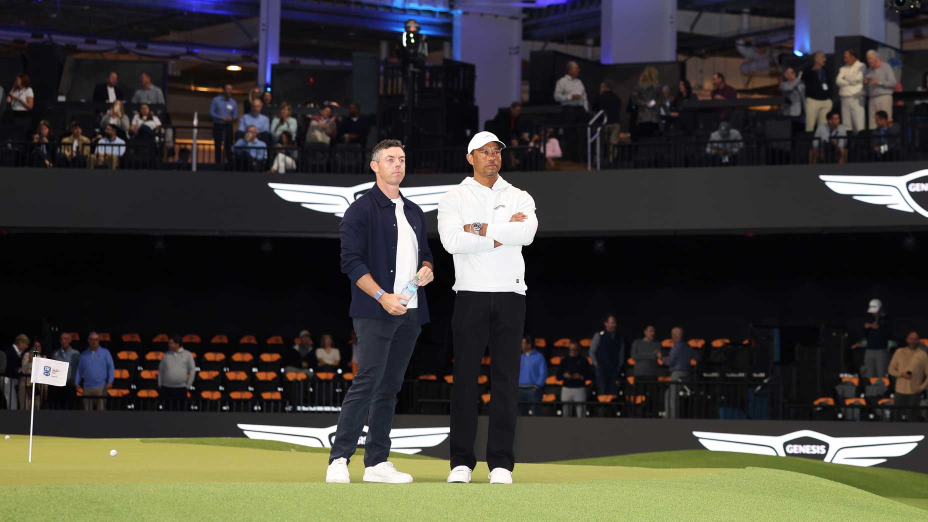 TGL founders Tiger Woods and Rory McIlroy look on before the TGL presented by SoFi match between the New York Golf Club and The Bay Golf Club at SoFi Center.