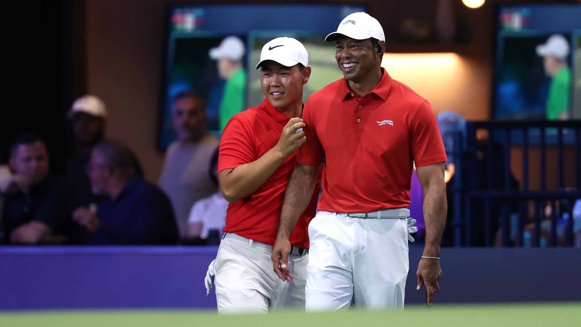 Tiger Woods and Tom Kim laugh during their TGL match.