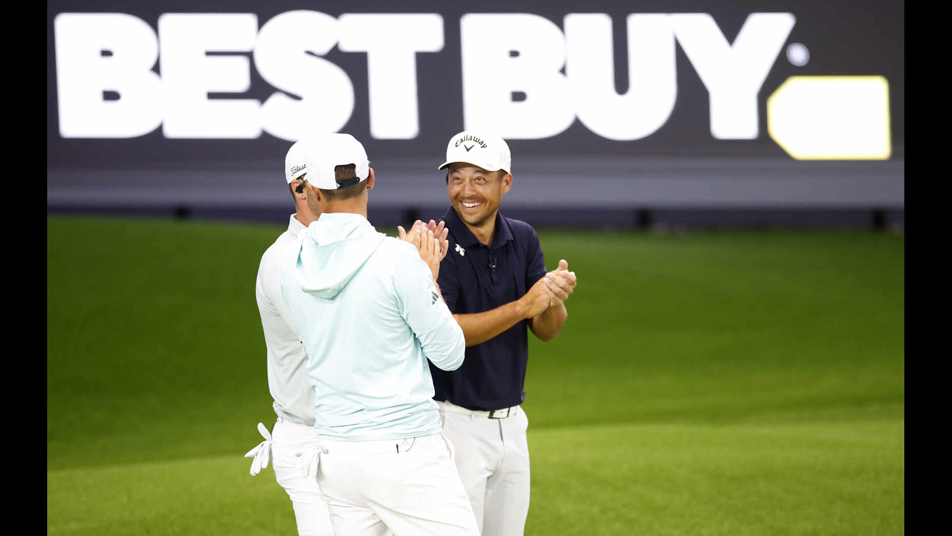 Xander Schauffele talks with Ludvig Aberg and Wyndham Clark during TGL's opening night.