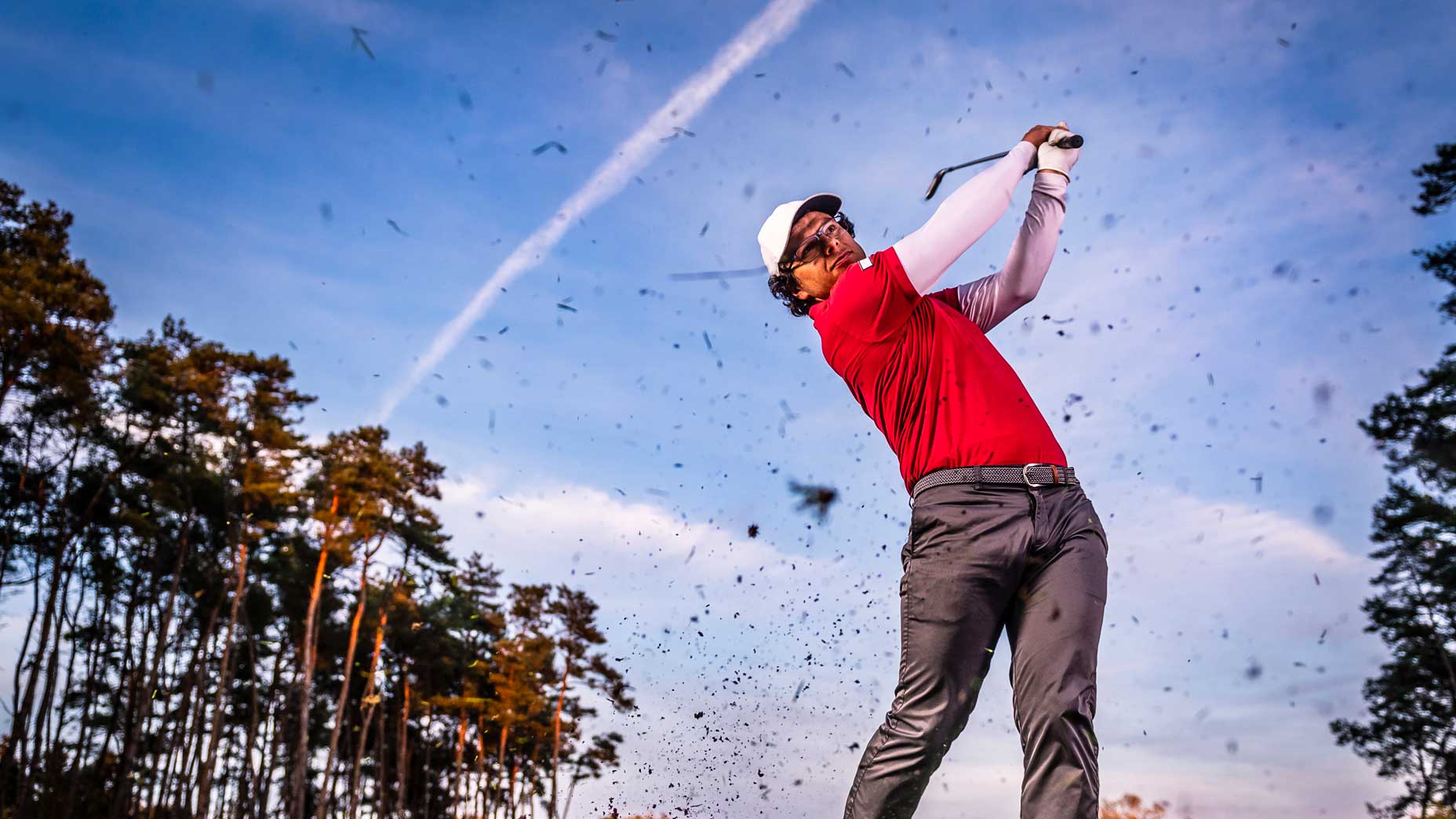 Golfer swinging a golf club on golf course