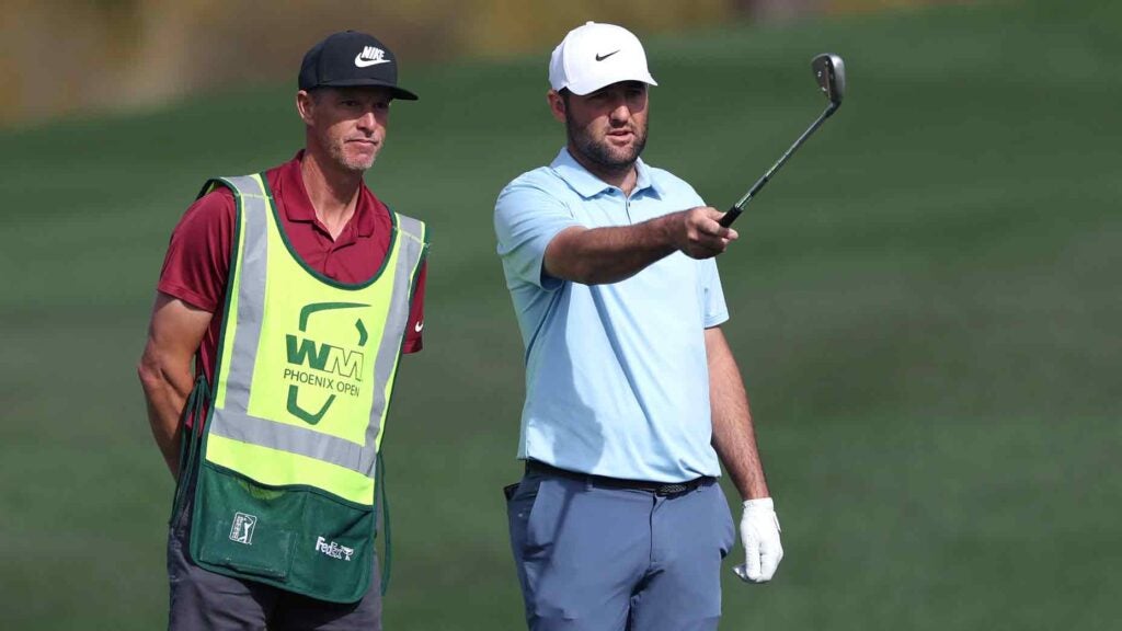 Scottie Scheffler of the United States prepares to plays a shot on the second hole alongside his caddie during the second round of the WM Phoenix Open 2025 at TPC Scottsdale on February 07, 2025 in Scottsdale, Arizona.