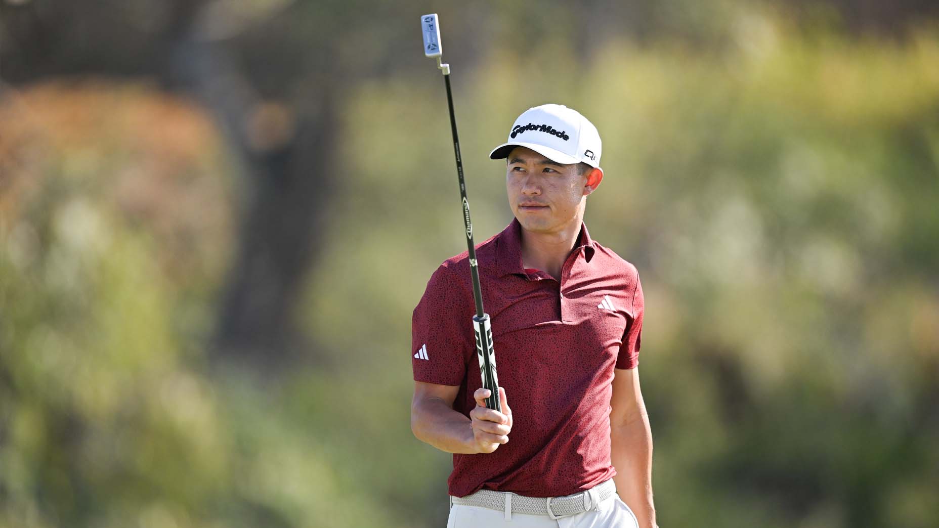 Collin Morikawa raises his putter during the final round of The Sentry.