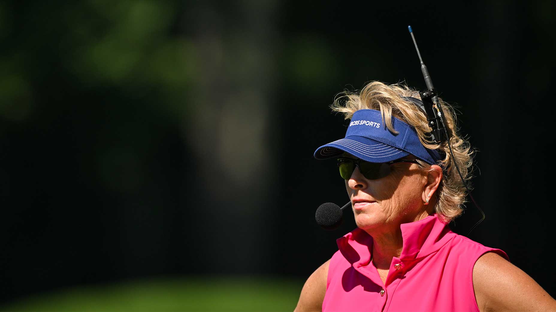 Dottie Pepper wore a blue hat and pink shirt at the PGA Championship with headphones.